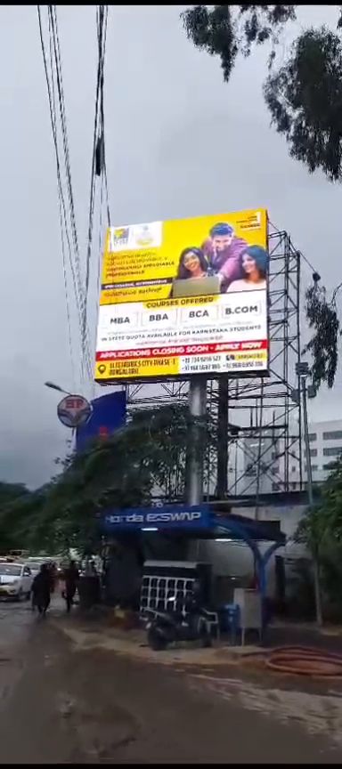 Outdoor LED display board mounted above a fuel station forecourt in Bengaluru