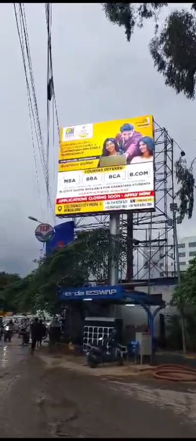 Outdoor LED display board mounted above a fuel station forecourt in Bengaluru