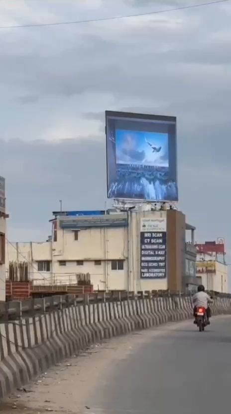 Rooftop LED billboard viewed from an elevated road