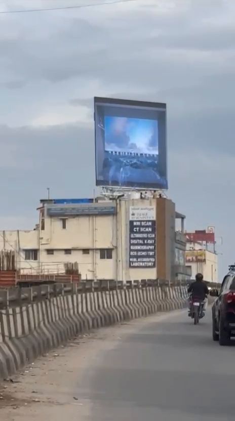Rooftop LED billboard viewed from an elevated road