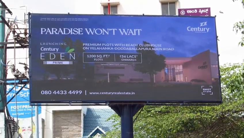 Wide-format outdoor LED billboard beside a road