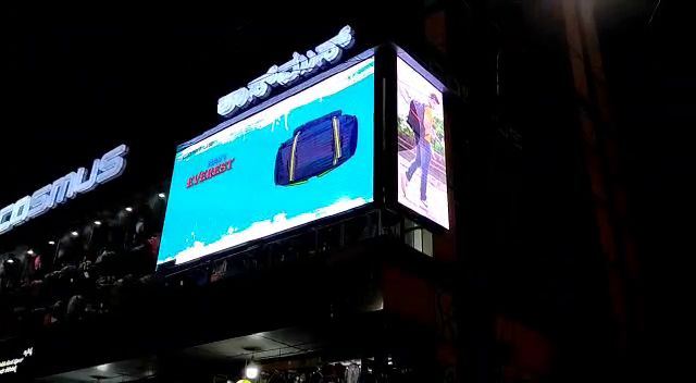 LED display board above a retail shop entrance at night