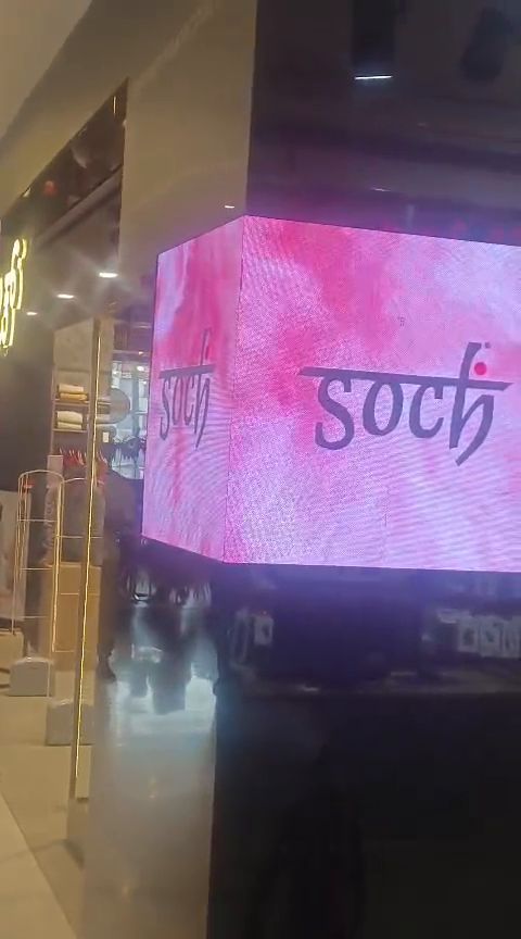 Four-sided indoor LED cube display inside a shopping mall