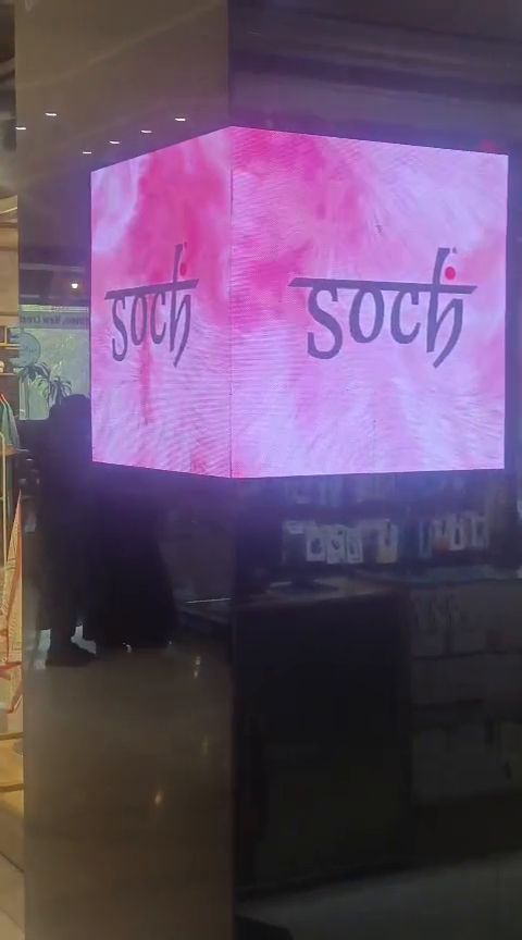 Four-sided indoor LED cube display inside a shopping mall