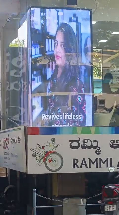 Freestanding LED digital standee on a footpath outside a shopfront