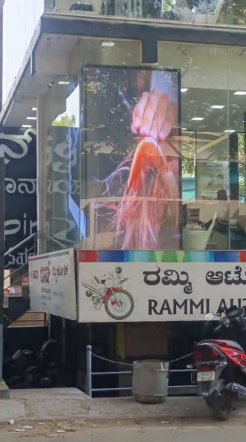 Freestanding LED digital standee on a footpath outside a shopfront