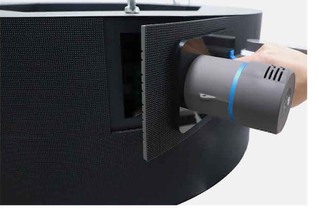 Magnetic suction tool lifting a soft LED panel off its frame from the front